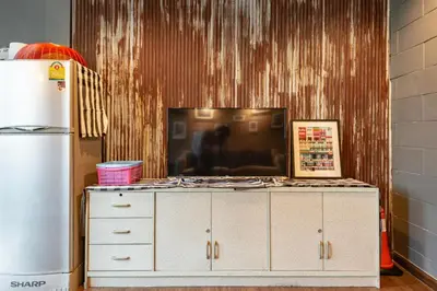 a tv sitting on top of a dresser in a kitchen at Tuk Tuk House 250m from MRT Sirikit in Bangkok