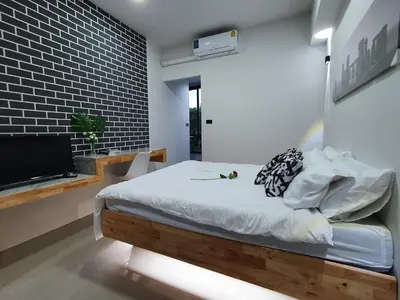 a bedroom with a bed and a flat screen tv at Irich residence South Samrong 6 Kms BTS-Pu Chao in Samut Prakan