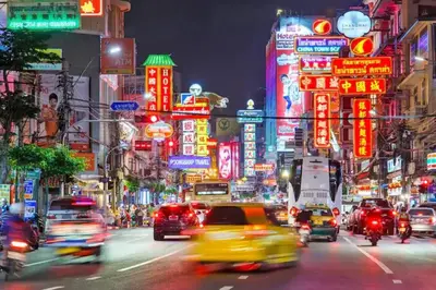a busy city street with lots of traffic at night at The Parkland Condominium in Bangkok