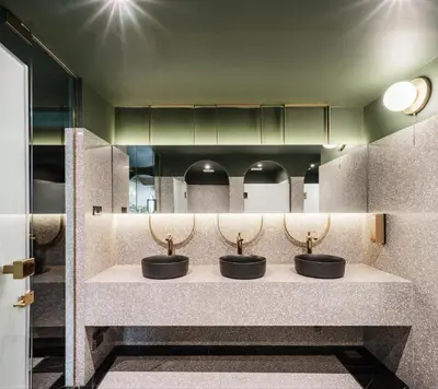 three sinks in a public restroom with mirrors at Cher Hostel Bangkok in Bangkok