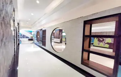 a hallway with a round mirror and a window at Capital O 75451 Podstel Hostel Bangkok in Bangkok