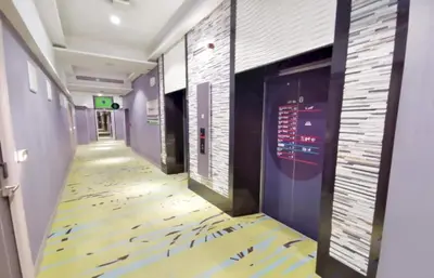 a corridor in a hospital with a floor with birds on it at Capital O 75451 Podstel Hostel Bangkok in Bangkok