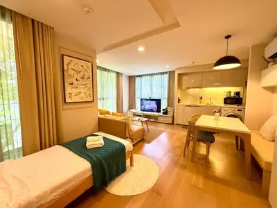 a small room with a bed and a living room at Cozy Spacious 1BR 2Bed GardenView 500m BTS Thonglo, Samitivej, SKV49, Rooftop Pool, Fast 500mbps wifi in Bangkok