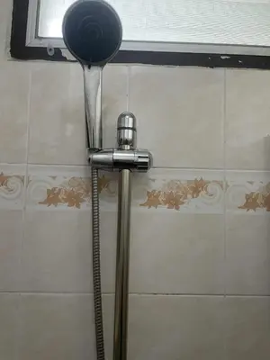 a shower head in the corner of a bathroom at Viriyapon in Bangkok