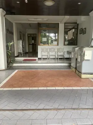 a lobby with chairs and a rug in front of a building at Viriyapon in Bangkok
