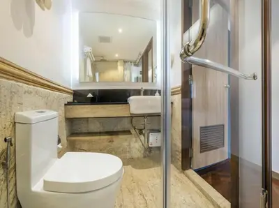 a bathroom with a toilet and a sink at The poshtel Bangkok By Benya BTS Phayathai in Bangkok