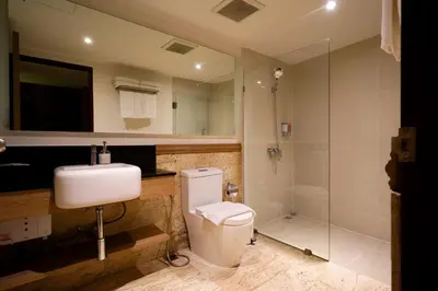 a bathroom with a toilet and a sink and a shower at The poshtel Bangkok By Benya BTS Phayathai in Bangkok