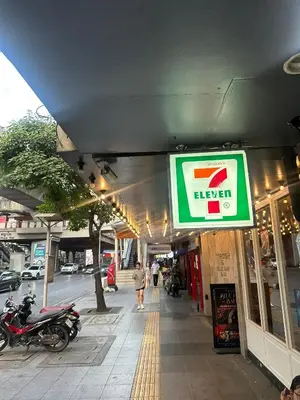 a sign for a store on a city street at The poshtel Bangkok By Benya BTS Phayathai in Bangkok