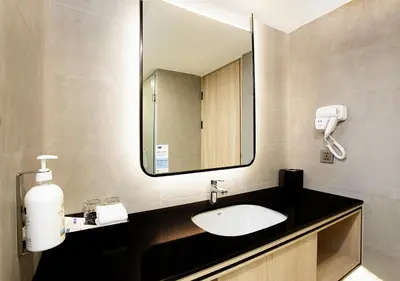 a bathroom with a sink and a mirror at Holiday Inn Express & Suites Bangkok Central Pier by IHG in Bangkok