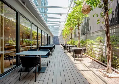 a corridor of a restaurant with tables and chairs at Holiday Inn Express & Suites Bangkok Central Pier by IHG in Bangkok