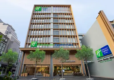 a tall building with a sign on the front of it at Holiday Inn Express & Suites Bangkok Central Pier by IHG in Bangkok