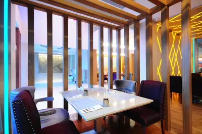 a dining room with a white table and chairs at One One Bangkok in Bangkok
