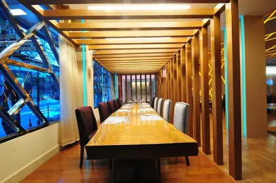 a long dining room with a long table and chairs at One One Bangkok in Bangkok