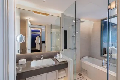 a bathroom with a sink and a shower and a tub at Grande Centre Point Surawong Bangkok in Bangkok