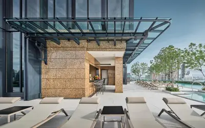 a view of a building with tables and chairs at Grande Centre Point Surawong Bangkok in Bangkok