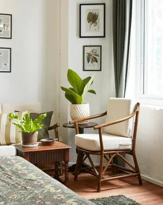 a bedroom with two chairs and a table and a window at Motu Bangkok in Bangkok