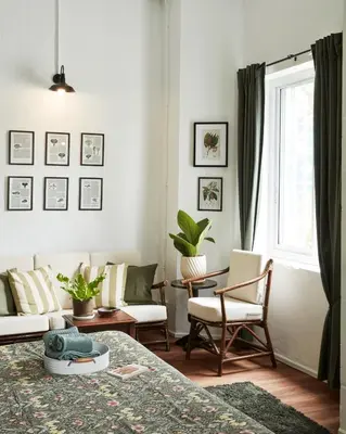 a living room with a bed and chairs and a window at Motu Bangkok in Bangkok