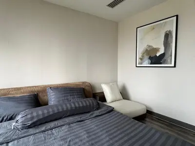 a bedroom with a bed and a chair at W8 CONDO, TOP Floor LUXE 3 Bedroom Penthouse, Hip central Bangkok area, 5 mins from Thonglo BTS station in Bangkok