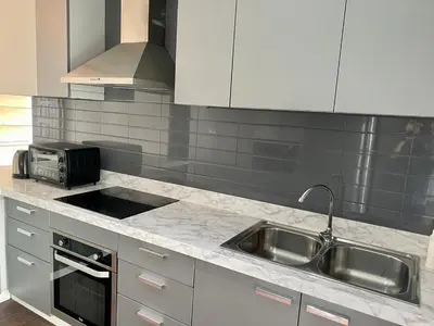 a kitchen with a sink and a microwave at W8 CONDO, TOP Floor LUXE 3 Bedroom Penthouse, Hip central Bangkok area, 5 mins from Thonglo BTS station in Bangkok