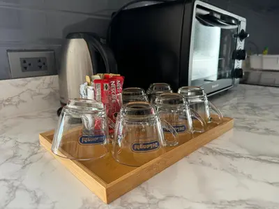 a group of glass jars on a wooden tray on a counter at W8 CONDO, TOP Floor LUXE 3 Bedroom Penthouse, Hip central Bangkok area, 5 mins from Thonglo BTS station in Bangkok