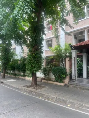 a tree on a sidewalk in front of a building at Viriyapon2 in Bangkok