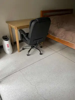 a computer chair sitting next to a desk next to a bed at Viriyapon2 in Bangkok
