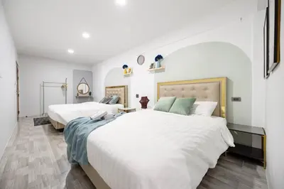 two beds in a room with white walls at Spacious 4BR Family Chatuchak Market 12 sleeps in Bangkok