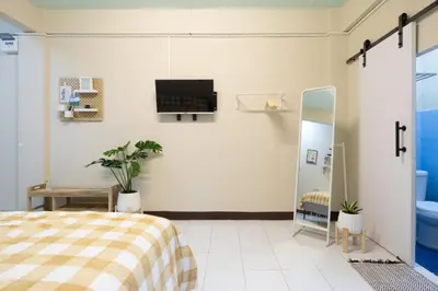 a bedroom with a bed and a tv on the wall at 204hideaway-Local Room with Street Food only 15 min walk to Skytrain in Bangkok