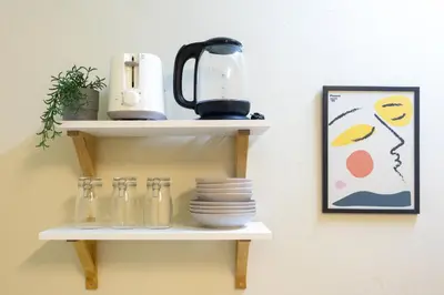 a shelf with dishes and a blender on a wall at 204hideaway-Local Room with Street Food only 15 min walk to Skytrain in Bangkok
