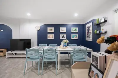 a dining room with blue walls and a table and chairs at Spacious 4BRTownhouse BTS Onnut 10 Sleeps with Parking in Amphoe Phra Khanong