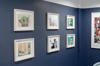 a group of framed pictures on a blue wall at Spacious 4BRTownhouse BTS Onnut 10 Sleeps with Parking in Amphoe Phra Khanong
