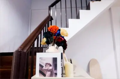 a vase with flowers on a shelf next to a staircase at Spacious 4BRTownhouse BTS Onnut 10 Sleeps with Parking in Amphoe Phra Khanong