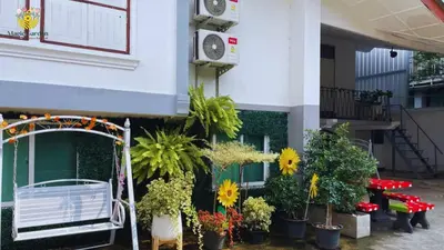 a building with a bunch of potted plants on it at Magic Garden Residence Bangkok in Bangkok