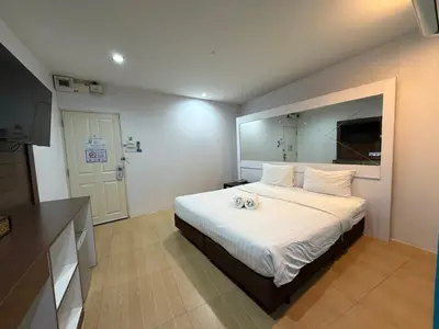 a bedroom with a large bed with a large mirror at Bed By Cruise Hotel At Samakkhi-Tivanont in Nonthaburi