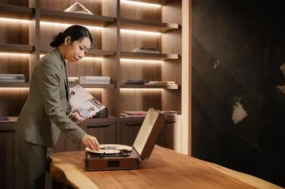 a woman standing in front of a table with a laptop at Ten Six Hundred, Chao Phraya, Bangkok by Preference, managed by The Ascott Limited in Bangkok