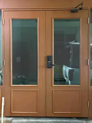 a wooden door with two windows on a building at DiscoveryHome3 at Pratunammarket in Bangkok