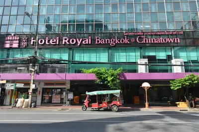a red golf cart parked in front of a building at Hotel Royal Bangkok in Bangkok