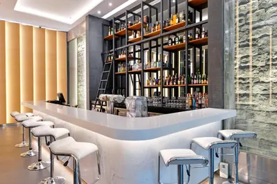 a bar in a restaurant with stools at Hotel Royal Bangkok in Bangkok