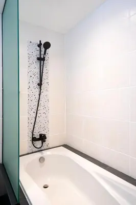 a bath tub in a bathroom with a shower at AndStay in Bangkok
