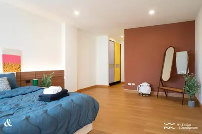 a bedroom with a blue bed and a chair at AndStay in Bangkok