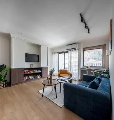 a living room with a blue couch and a table at AndStay in Bangkok