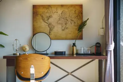 a dressing table with a mirror and a chair at NORN Riverside Bangkok Hotel - นอนริมน้ำ in Bangkok