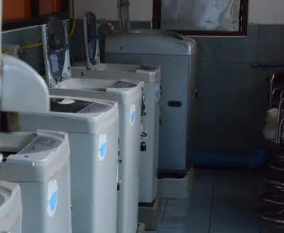 a bathroom with three washing machines and a sink at View Place Hotel & Residence Lat Phrao 130 in Bangkok