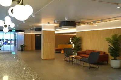 a lobby with couches and a table and chairs at View Place Hotel & Residence Lat Phrao 130 in Bangkok