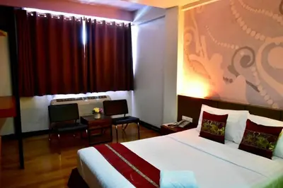 a hotel room with a bed and a window at Happyland Mansion in Bangkok