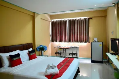 a hotel room with a bed with a stuffed animal on it at Happyland Mansion in Bangkok