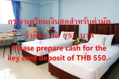 a bedroom with a large bed with a price sign on it at Happyland Mansion in Bangkok