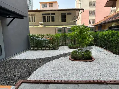 a courtyard with a garden with a potted plant at D Night Suite Hotel in Bangkok