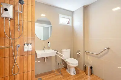a bathroom with a toilet and a sink and a shower at Diya Hotel Bangkok in Amphoe Phra Khanong