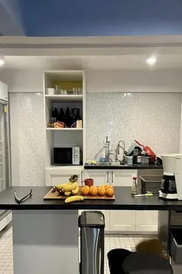 a kitchen with a counter with bananas and oranges on it at El Biografo in Bangkok